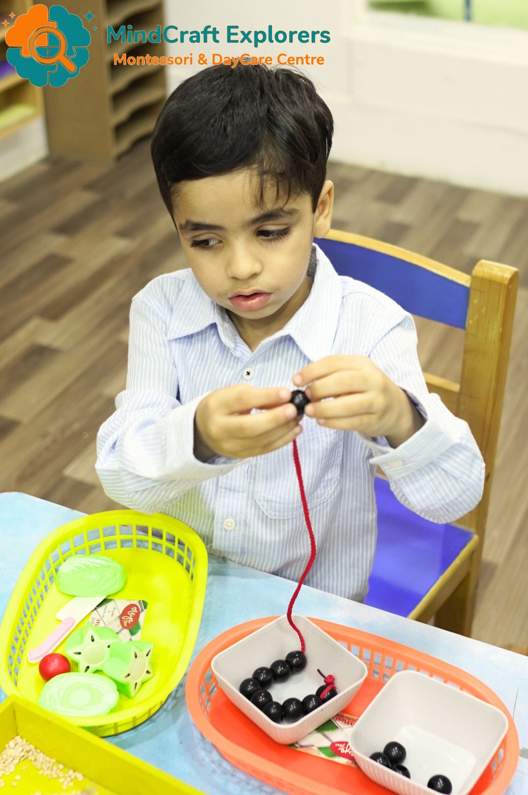 A boy threading beads onto a string