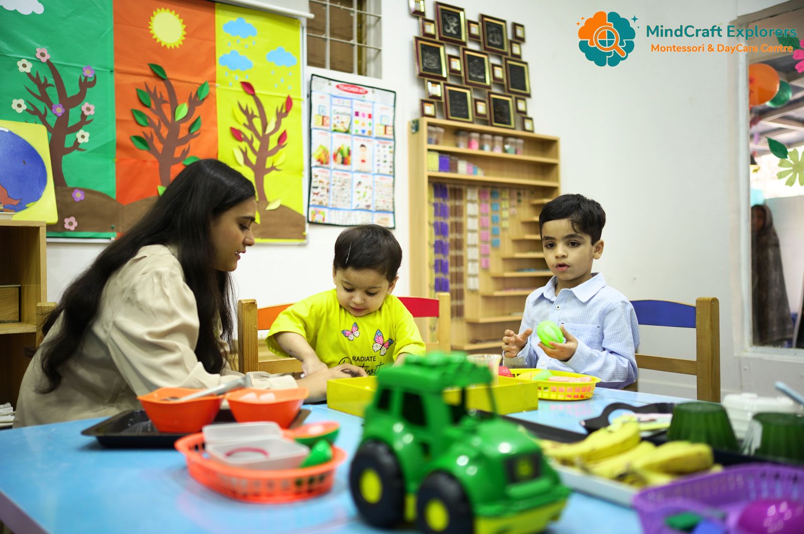 Children and teachers working together at a classroom table
